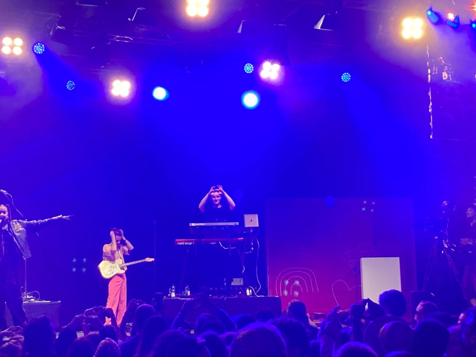 Tim Bond making a heart shape with his hands on stage
