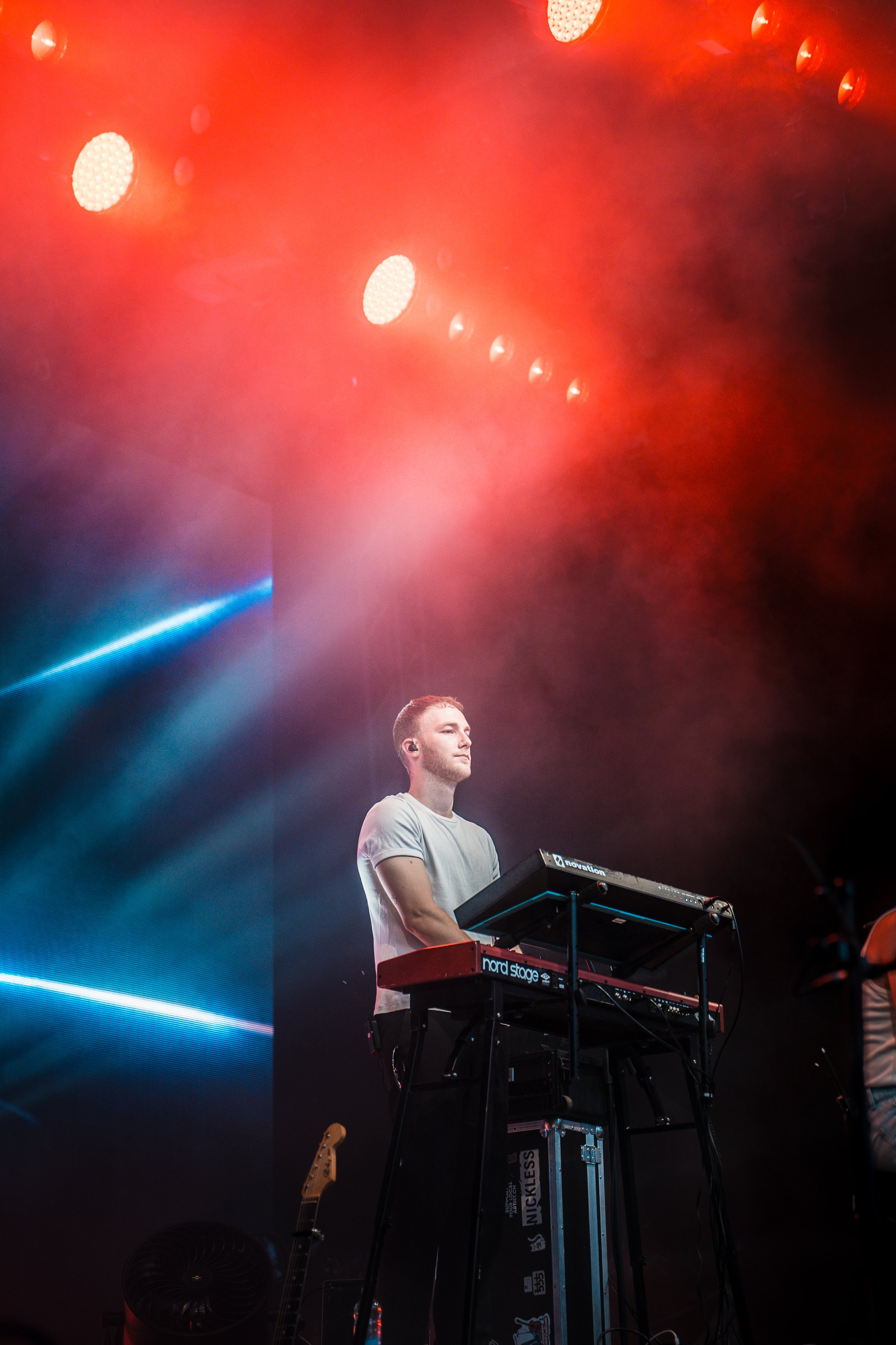 Tim Bond on stage under red and blue lights